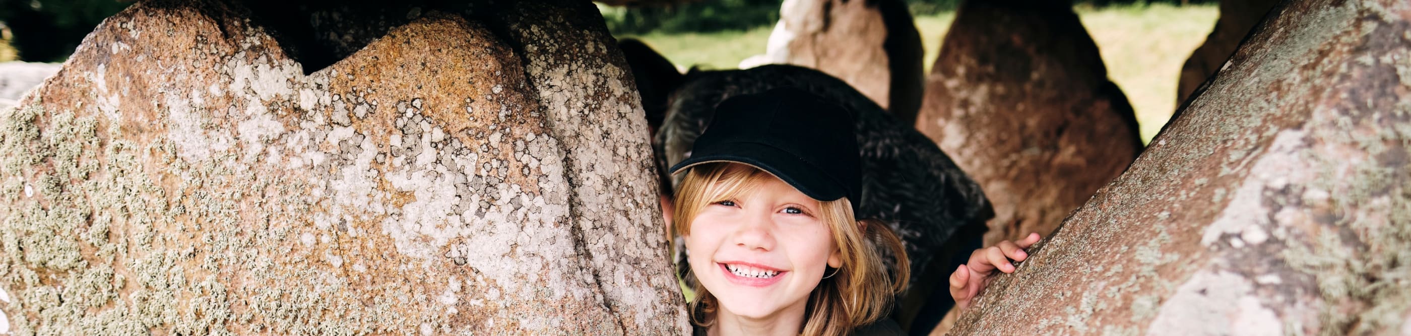 Faldouet Dolmen child poses with stones