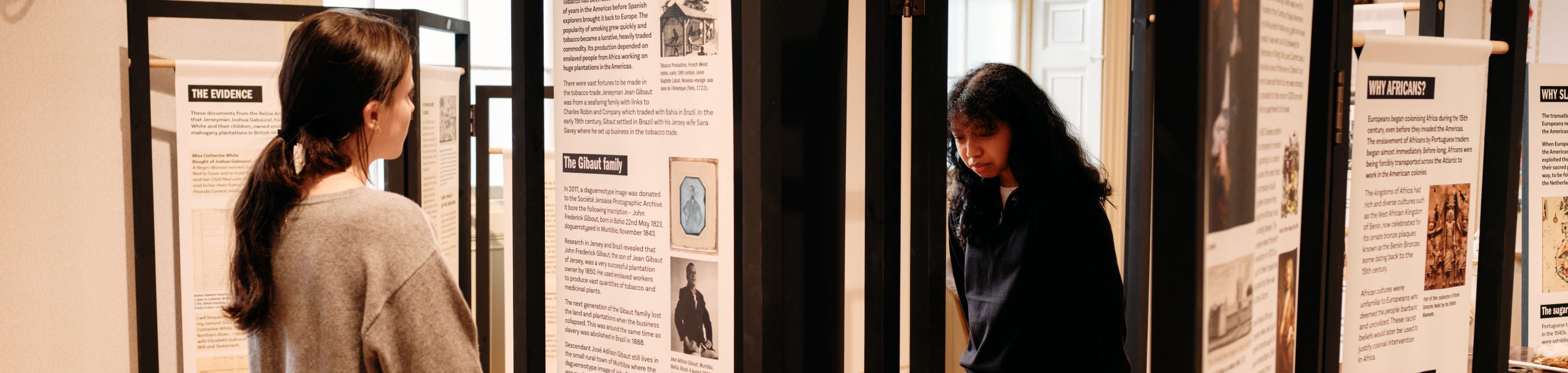 Two people look at exhibition panels