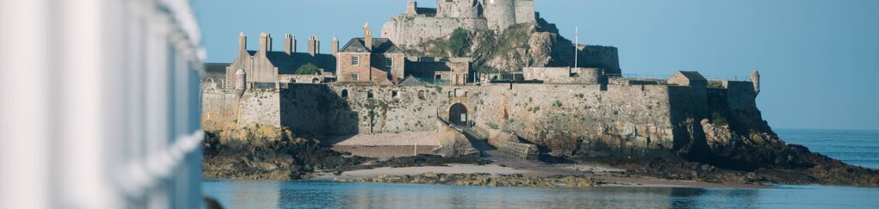 Calm sea in front of an island castle