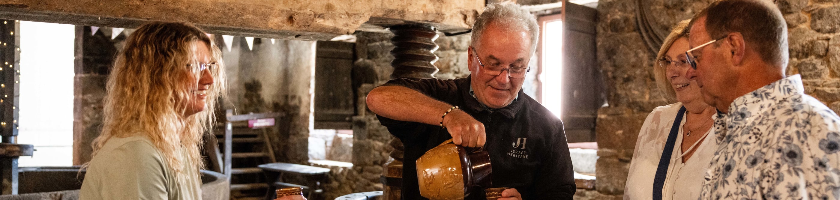 four people tasting cider