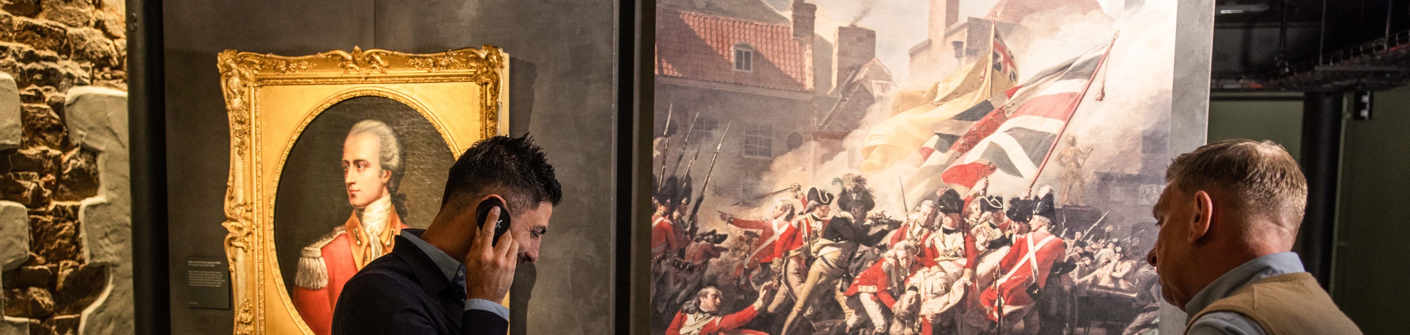 people listen to some audio as part of an exhibition