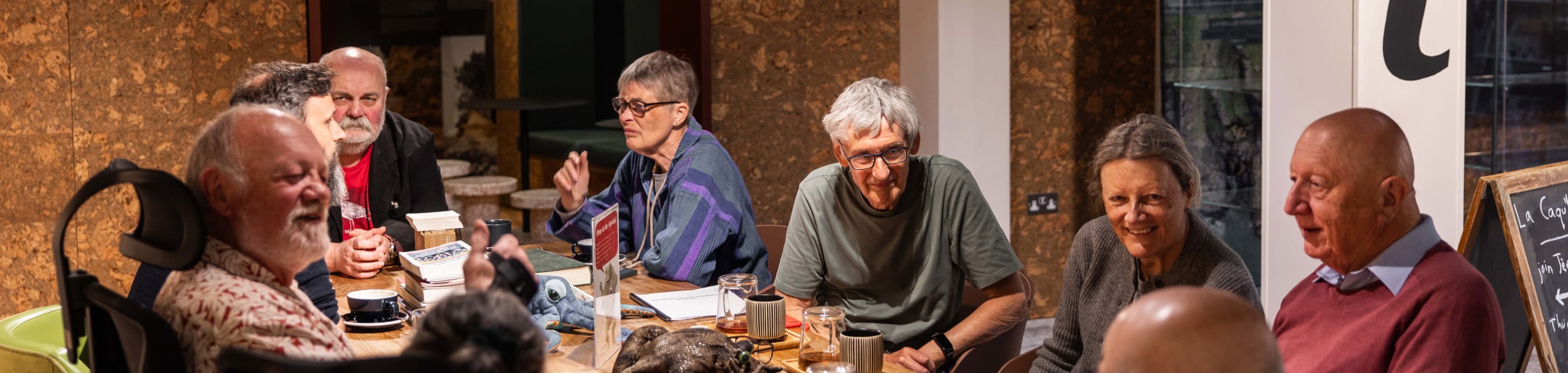 group sit around a large table