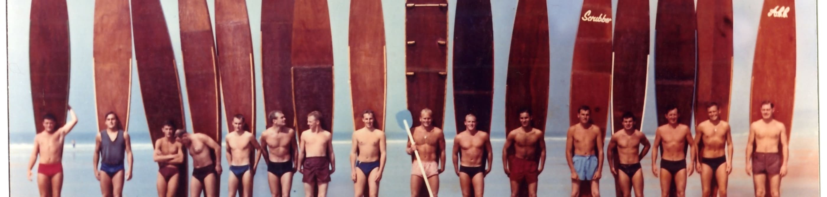 Group of male surfers with long boards