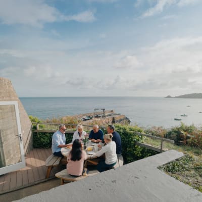 Group of people sit at a picnic bench