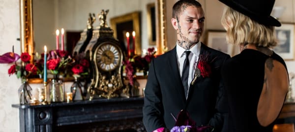 Two people stand infront of a mirror