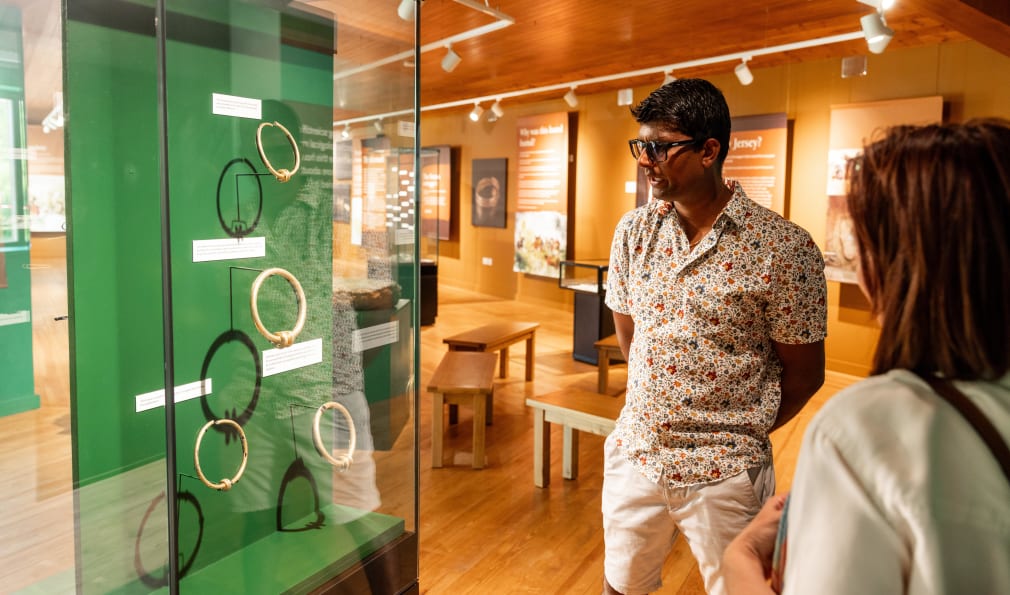 Man and women look at an exhibition case