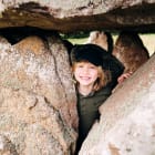 Faldouet Dolmen child poses with stones