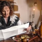 Living History Character reads scroll