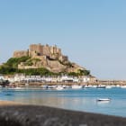 A castle in the background within a harbour