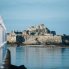 Calm sea in front of an island castle