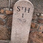 a granite marker which shows 1 mile to St Helier