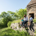 Woman and children sit on a stone wall