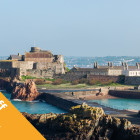 A castle building surrounded by sea