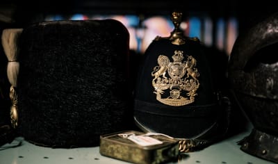 Sir Francis Cook regimental hats on shelf