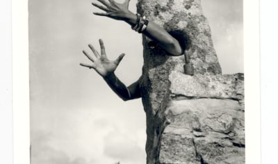 Artwork were arms come out of a rock