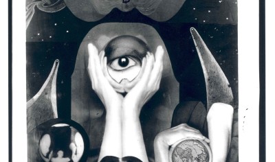 A surrealist photo focusing on hands and an eye
