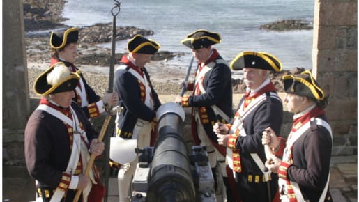 six uniformed men stand around a cannon