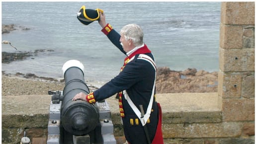 One man in uniform holds onto a cannon