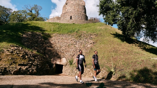 Two visitors walk at an ancient site