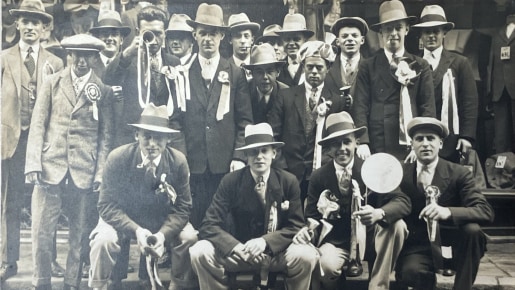 Postcard of a group of football spectators