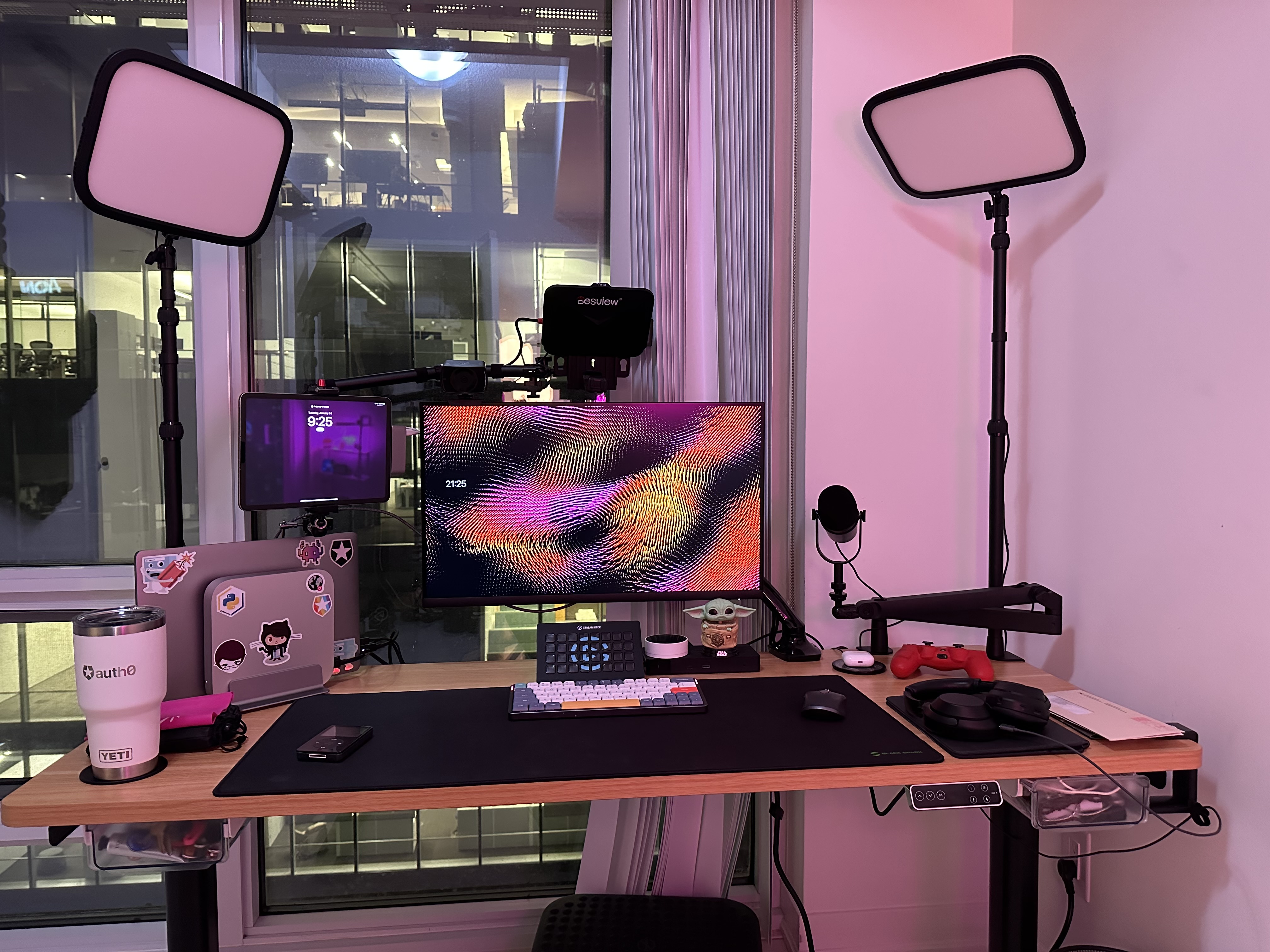 A photo of my desk at night, you can see the computer monitor, computer, keyboard, mouse and other things like the ones in the lists of this post.