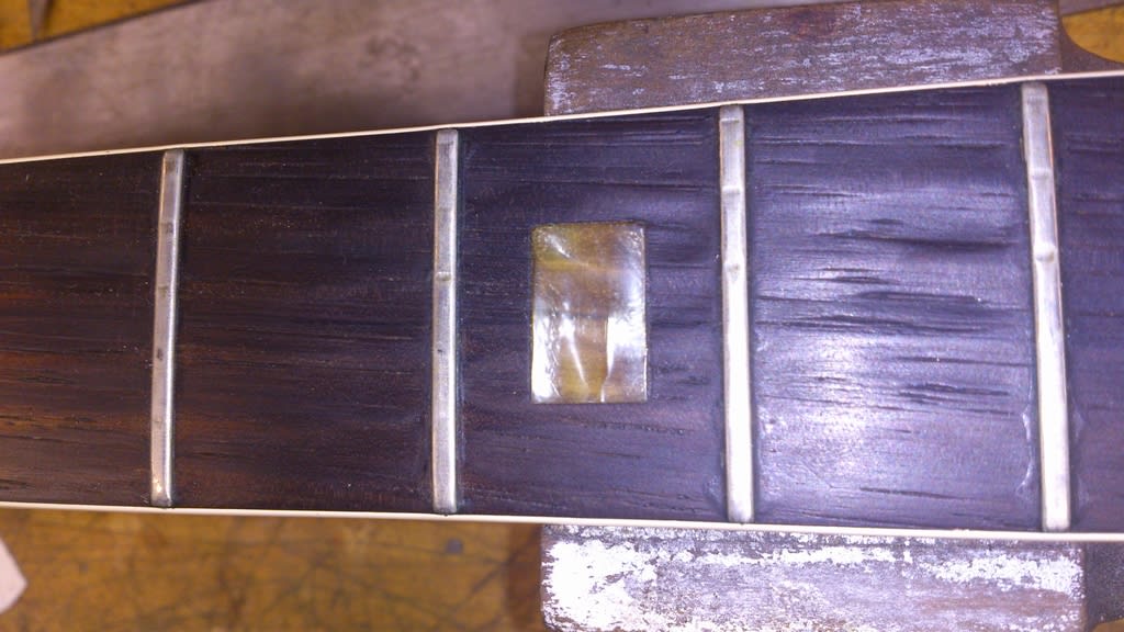 The frets are orignial and they're so low that the strings are wearing away the rosewood fingerboard...Not Good!...we'll refret this and fill the worst of the fingerboard wear. Can you see how age and light has faded the block inlays? They're almost transparent!