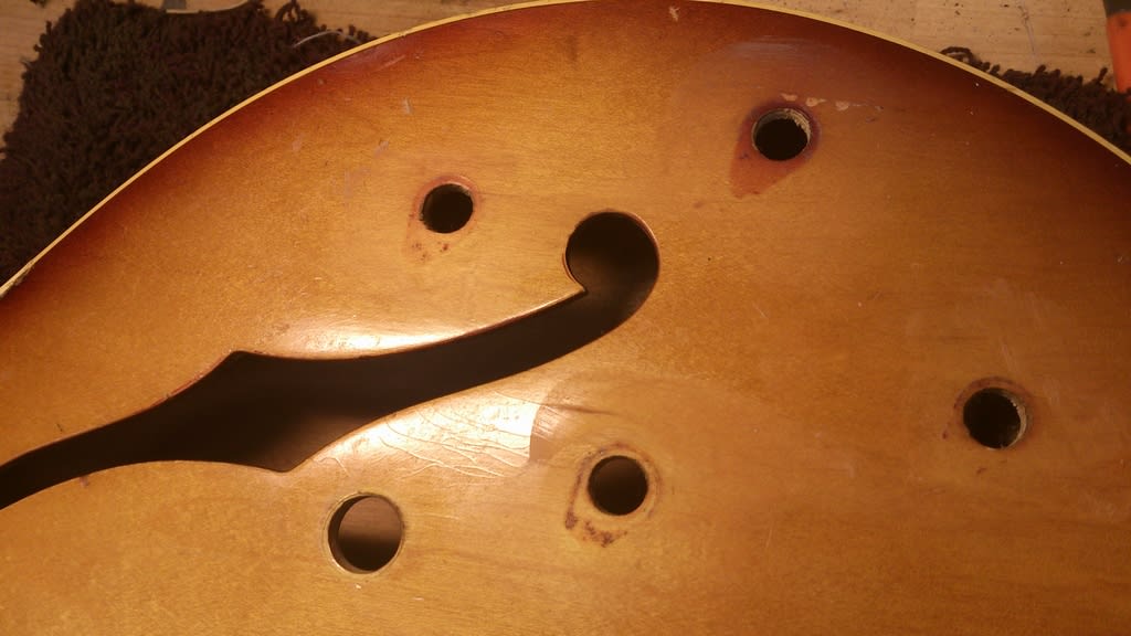I'm going to fill and refinish the original control holes sympathetically. You can see how the finished has faded or has not faded with regard to what was originally the pointer for the bridge tone pot