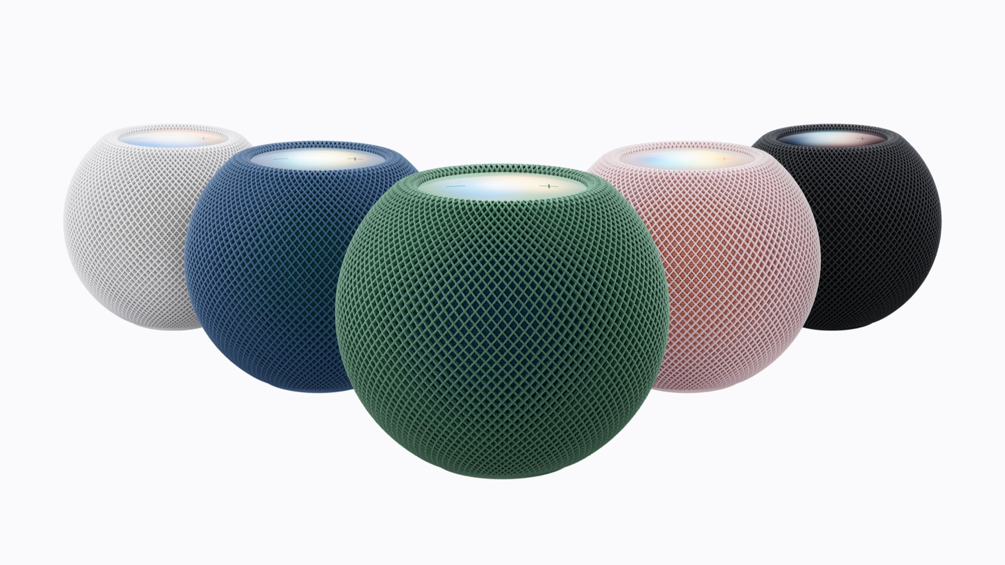 Five HomePod mini 2 speakers in pink, green, blue, white and midnight arranged in a row on a white background