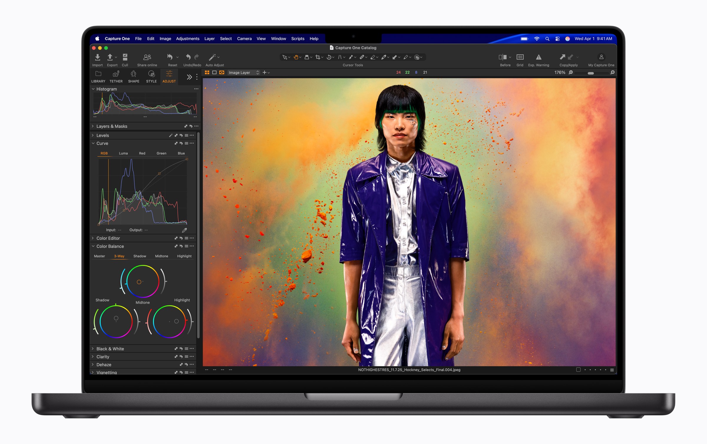 Current 14-inch MacBook Pro in space black, front view, with the camera notch at the top of the screen and a photo-editing app open
