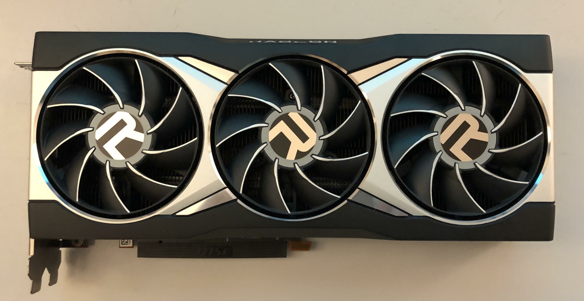 AMD Radeon RX 6900 XT reference graphics card seen from the front, with three fans and a silver and black shroud