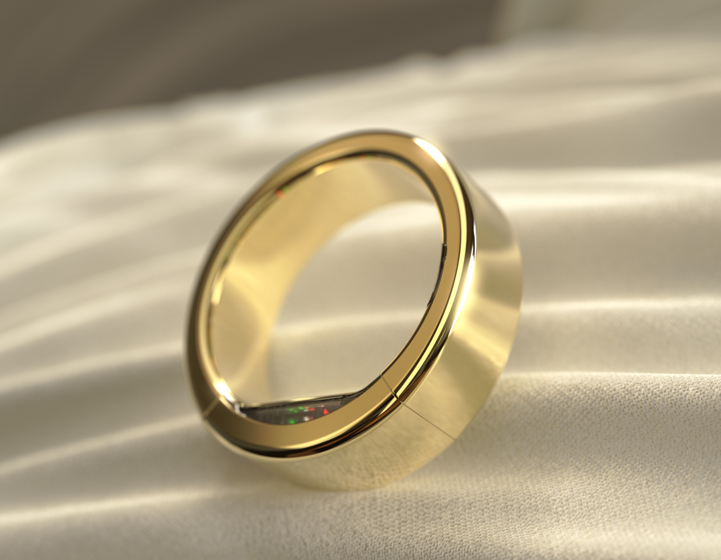 Ultrahuman Ring Pro smart ring in Bionic Gold resting on cream fabric