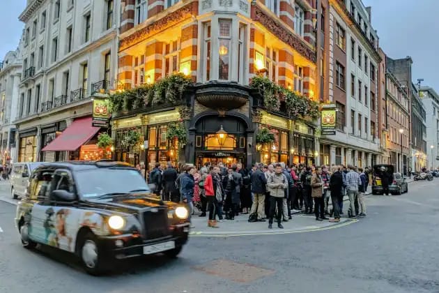 Soho London street scene with colourful buildings and pedestrians