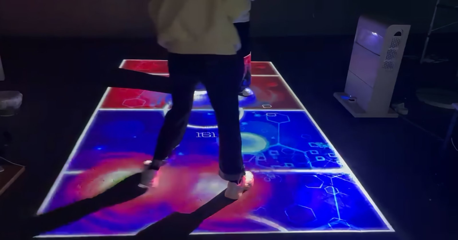 Infinity Mobile Laser Interactive Floor Projector Tower — real use, person playing interactive floor game