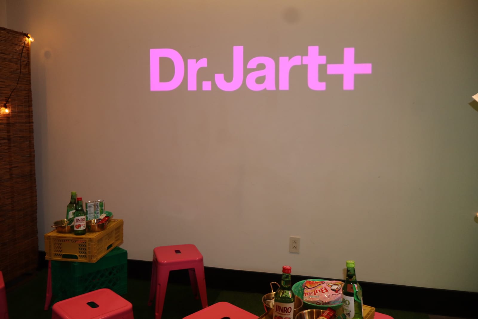 Dr. Jart+ logo projected on a wall at the Dr. Jart+ Pocha event, an Estée Lauder Companies brand activation