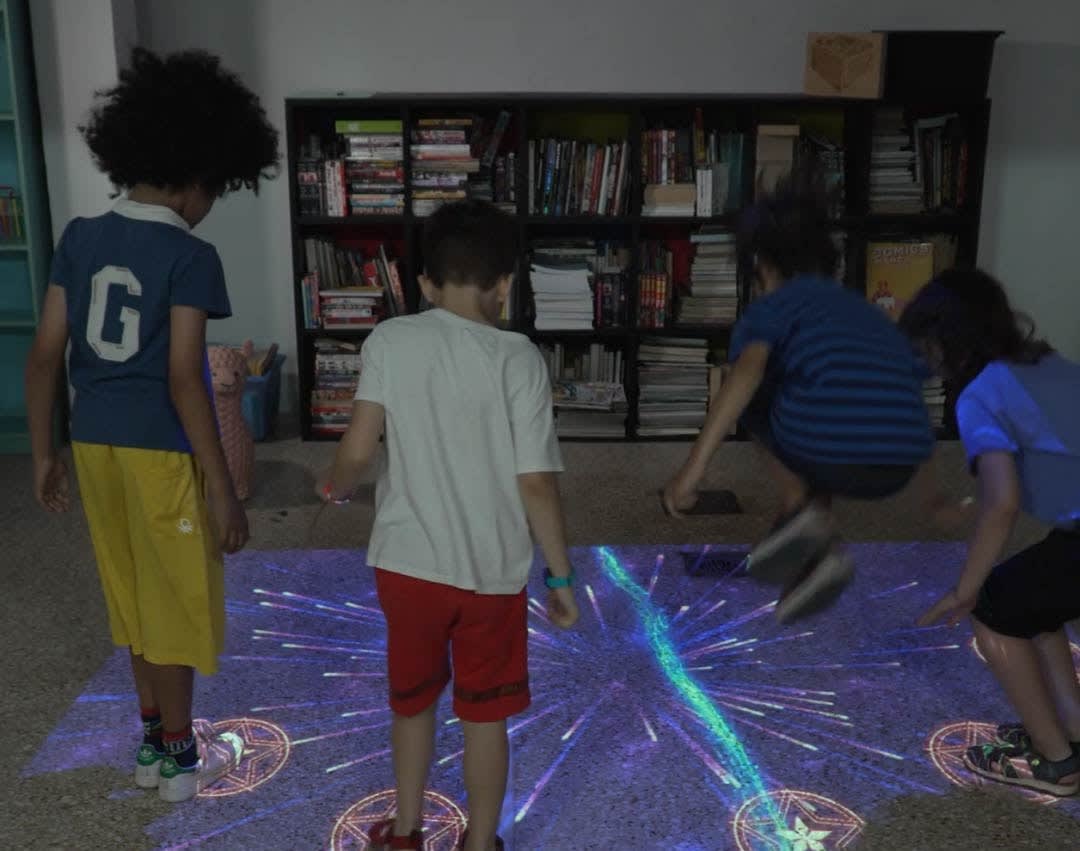 Video: kids jump on star targets as cosmic fireworks burst across an interactive floor
