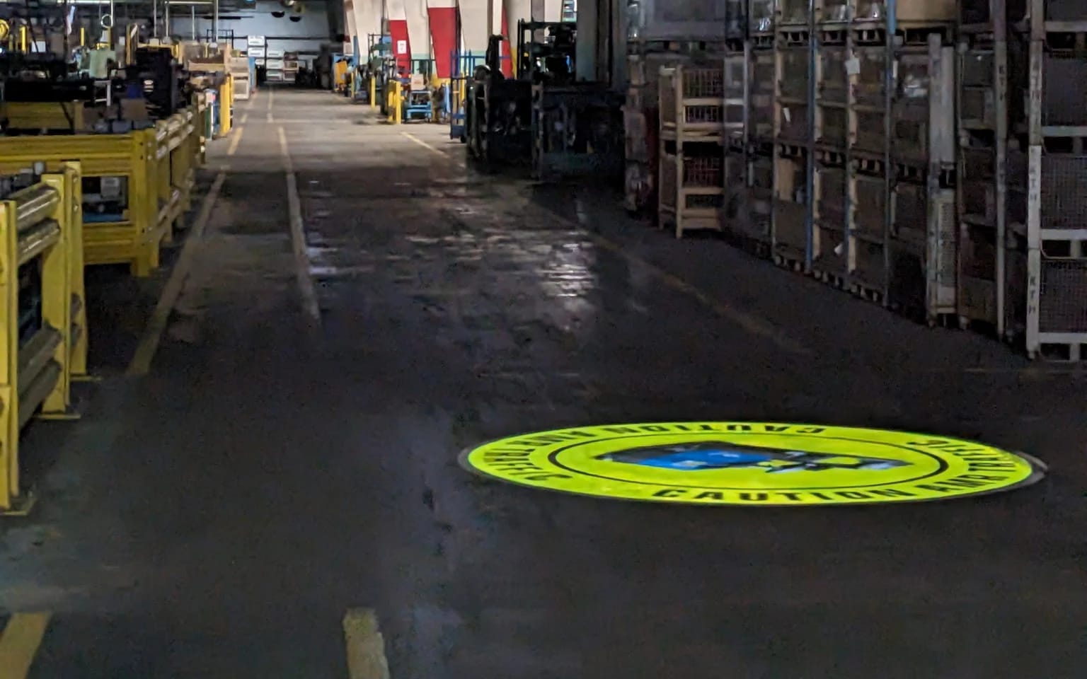 Warehouse safety — Forklift caution sign projected in a working factory aisle