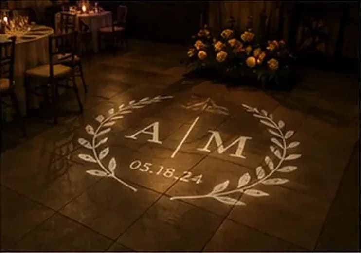 Couple sharing a first dance under a projected heart monogram — Infinity Projectors