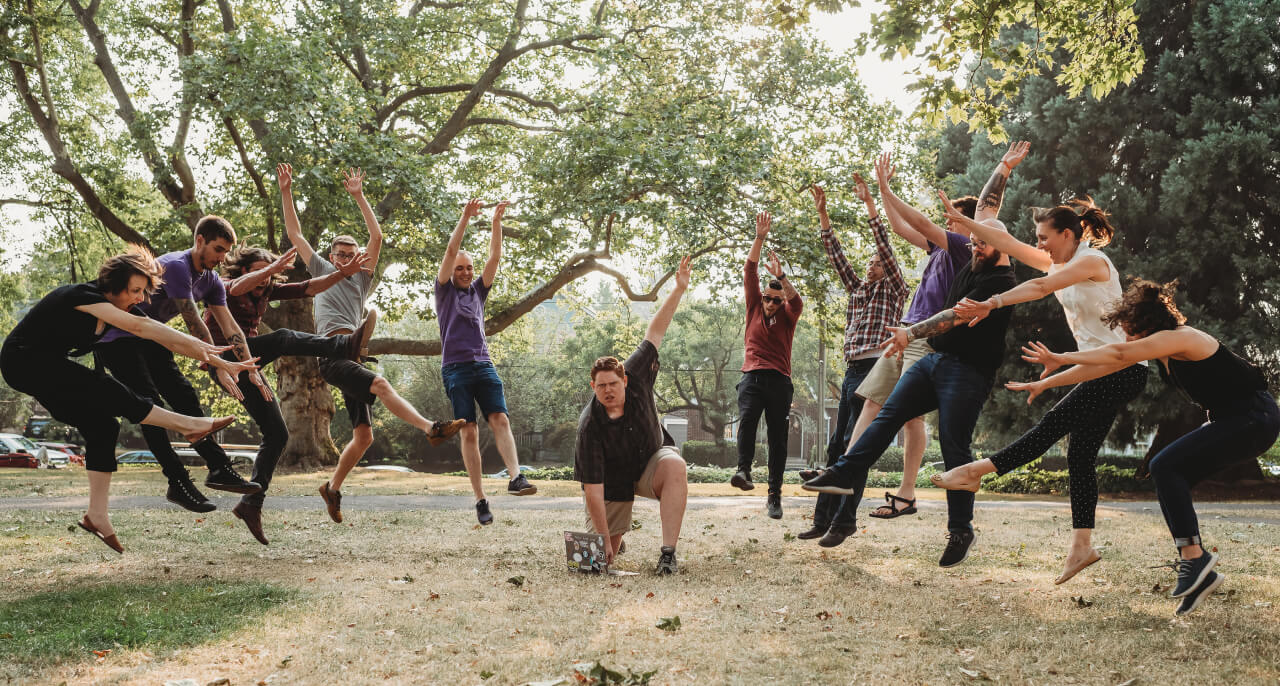 The Gatsby team jumping in a way that makes it look like they’re flying away from an explosion.