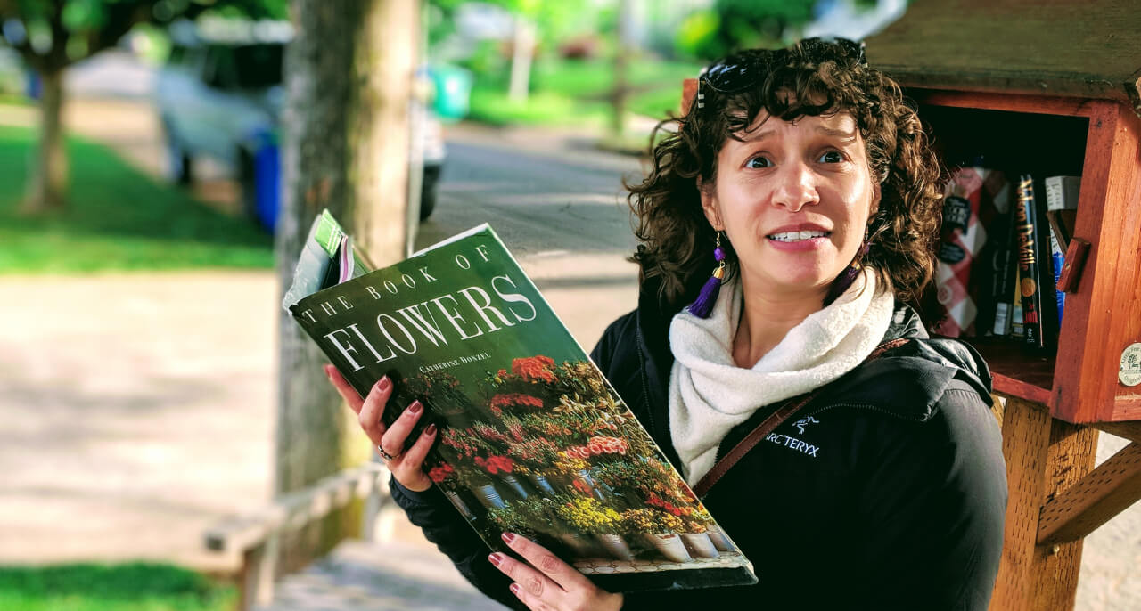 Marisa reading a book about flowers.