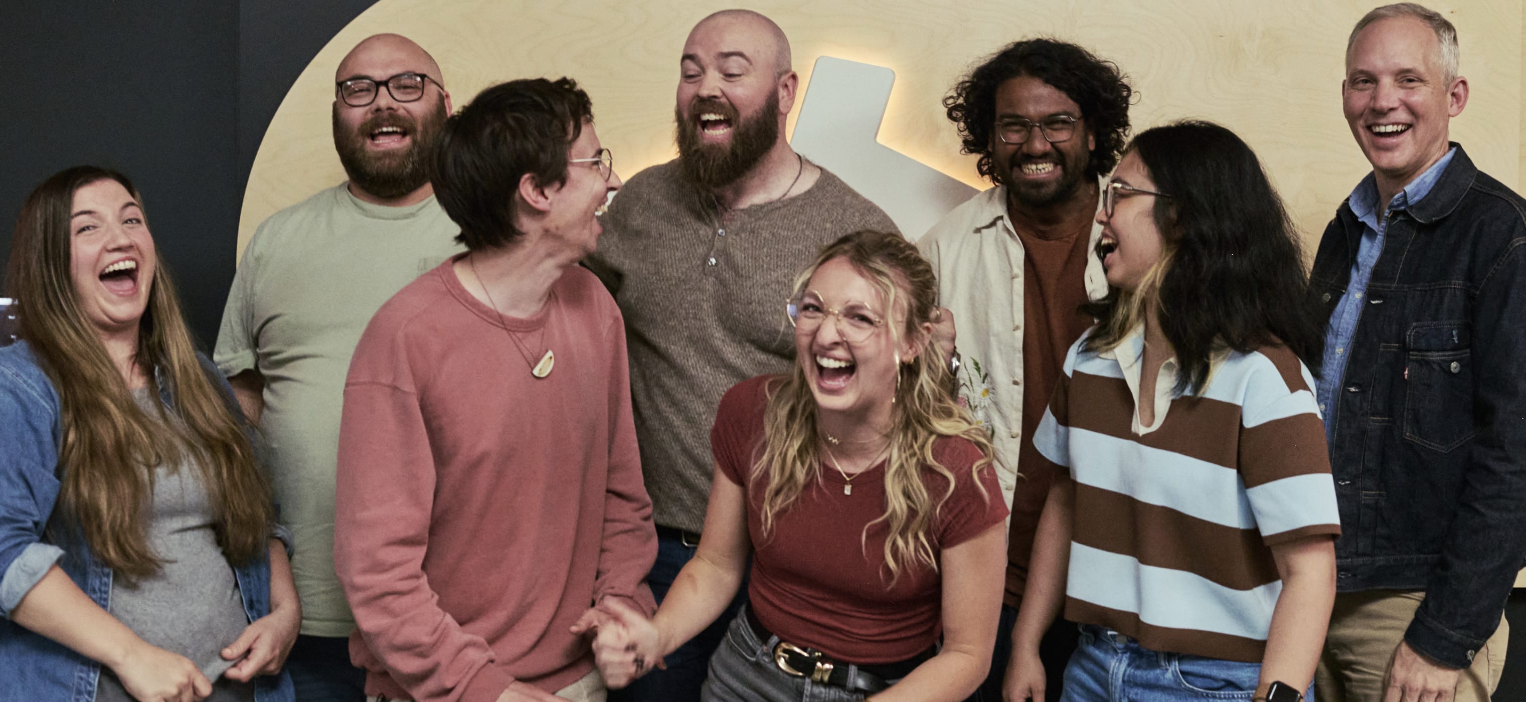 The devs from this episode laughing together.