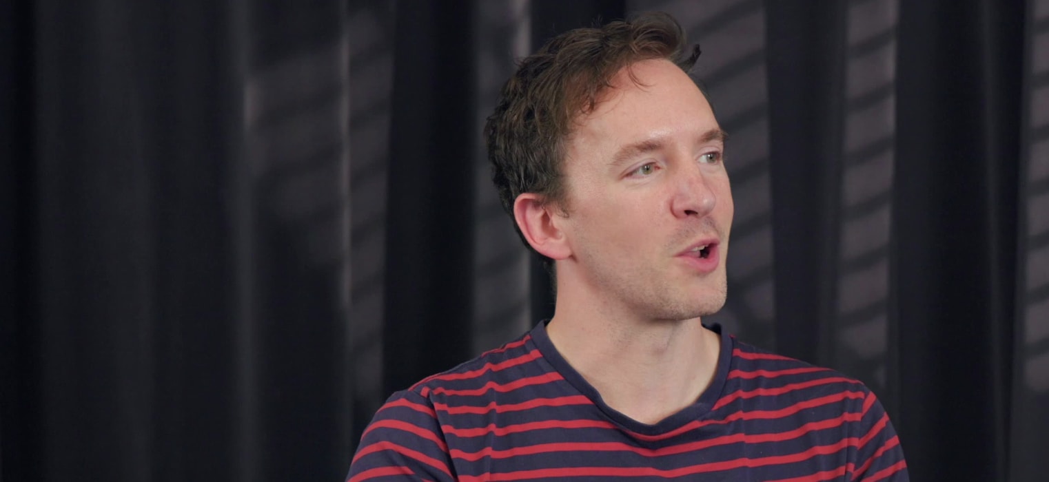 Daniel Roe speaking with a slight smile.