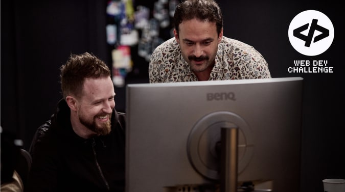 Adam and Alex looking at a monitor together with the Web Dev Challenge logo overlaid