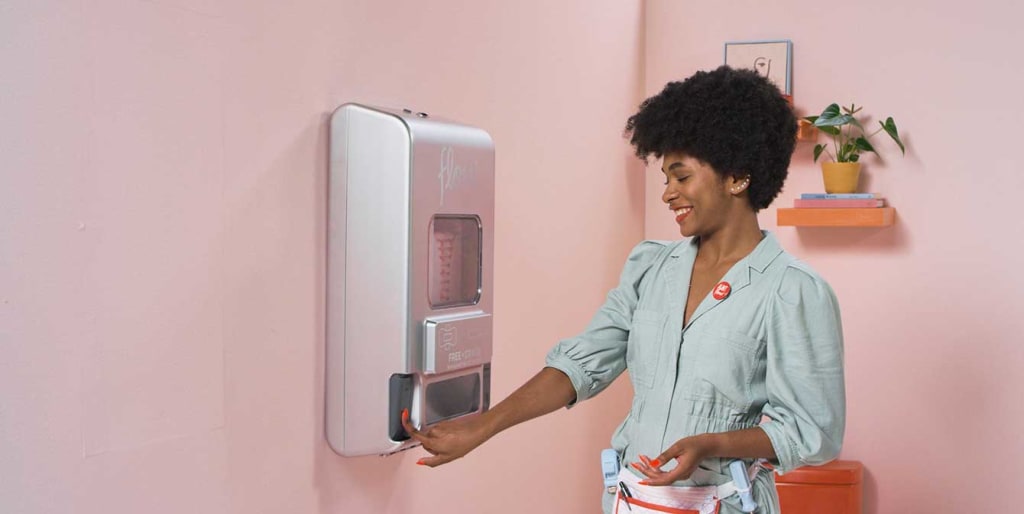 Black woman using a free vend period products dispenser