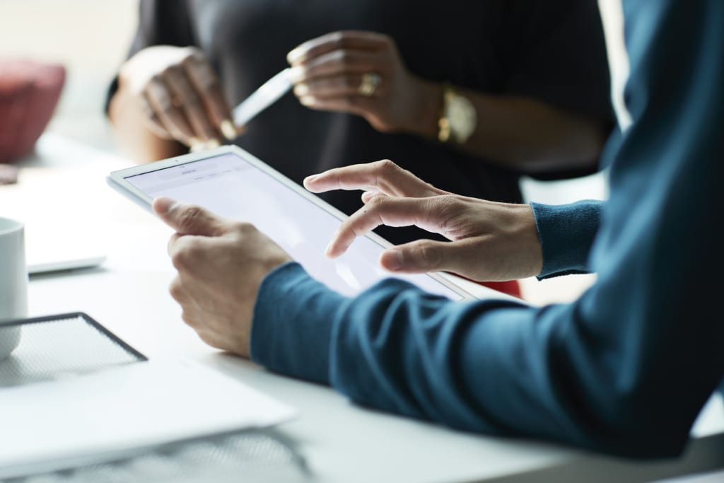 Business person scrolling on tablet