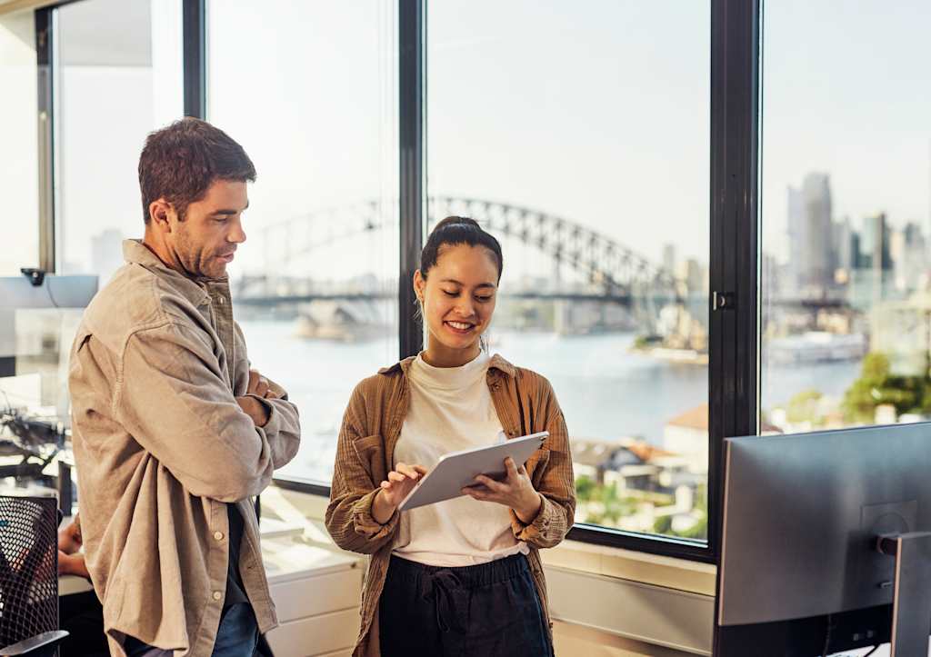 Multicultural professionals driving innovation in sydneys office environment | jllt 2 technical professionals interacting