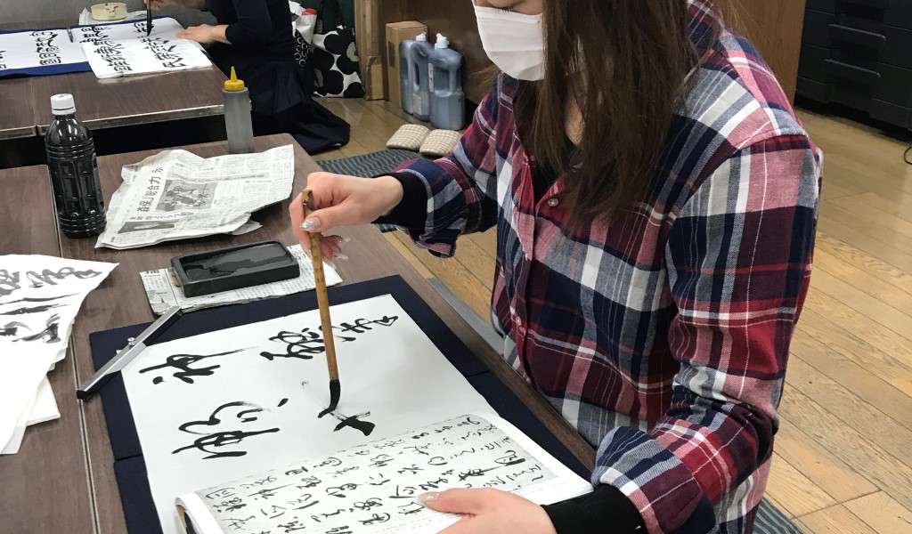 A girl practising characters at a shodo school