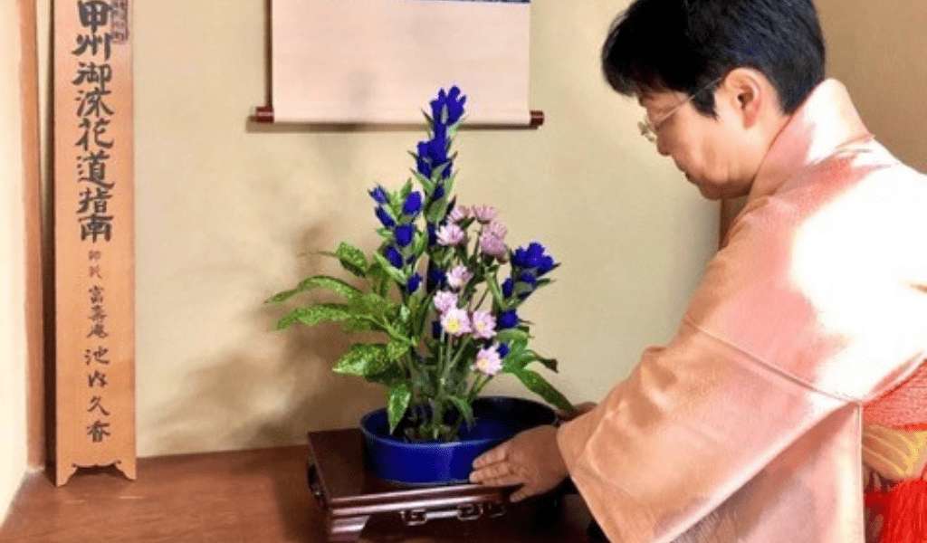 Kikuko Akimune placing ikebana, Japanese flower arrangement in a tokonoma, an alcove in a Japansese-style room