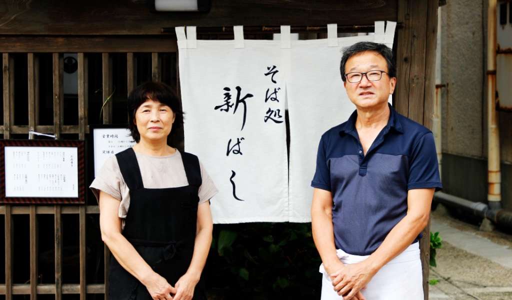 Yoshinori Shibazaki & his wife, Keiko standing outside their restaurant