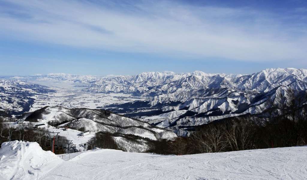 Gala Yuzawa Ski Resort, ski hills surrounded by mountains covered in snow in Japan