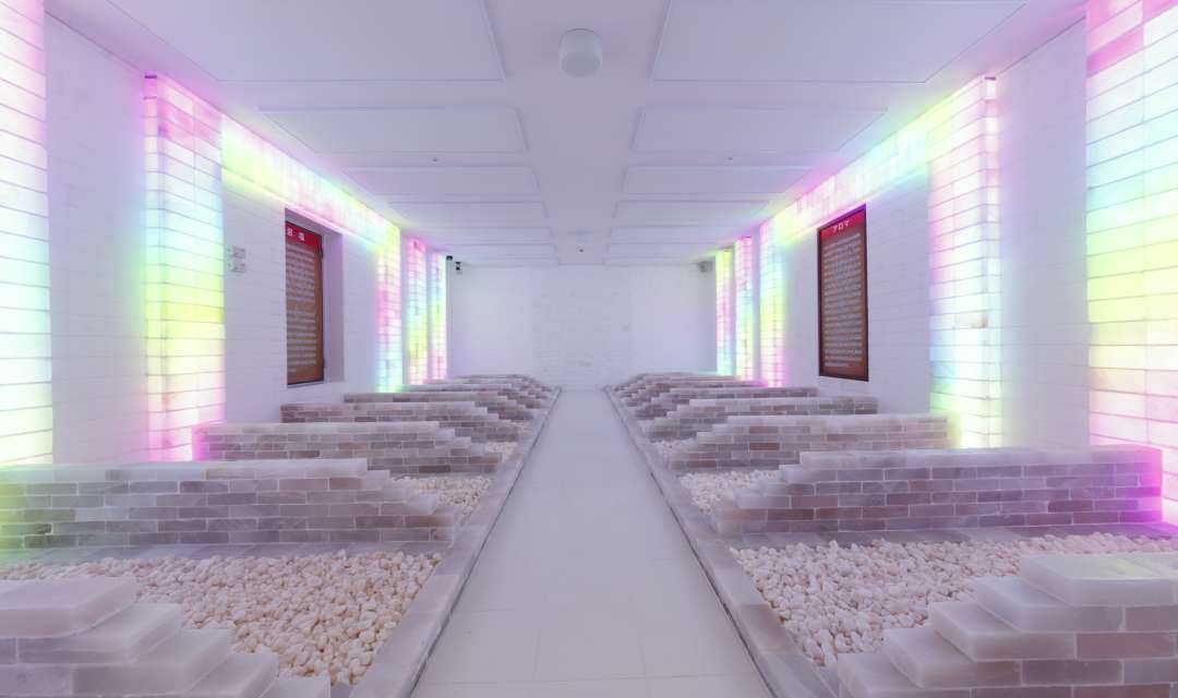 White room with brick partitions and coloured lights